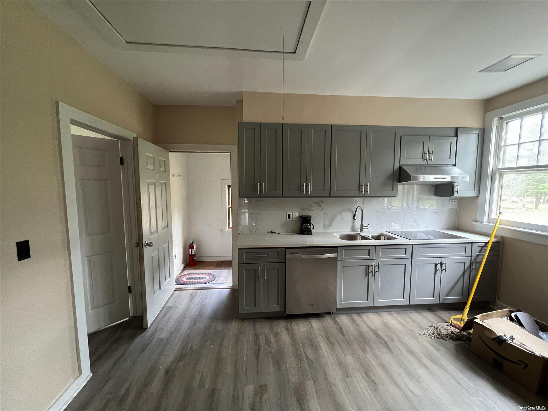 127 Kirkwood Road Stroudsburg, PA 18360 - Photo 6 of 20 a kitchen with a sink wooden floor and a window