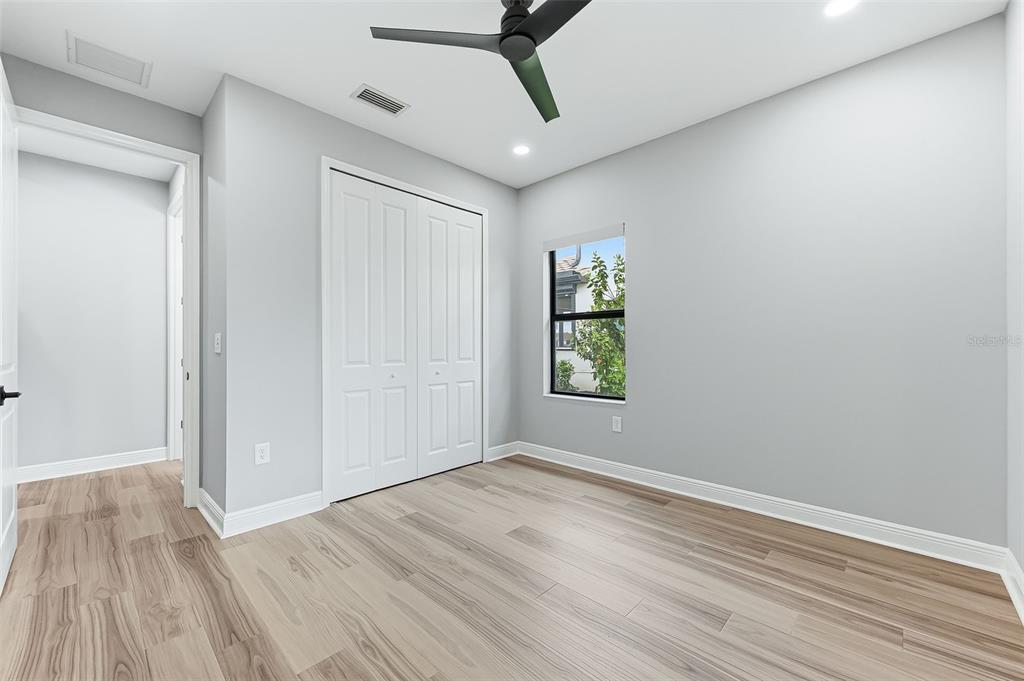 4191 Pegasus Way Naples, FL 34120 - Photo 29 of 48 a view of empty room with wooden floor and fan