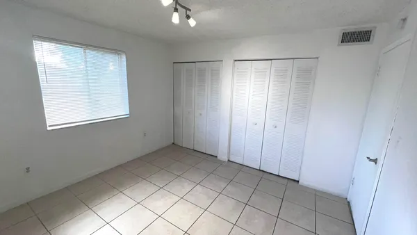 a view of an empty room with windows