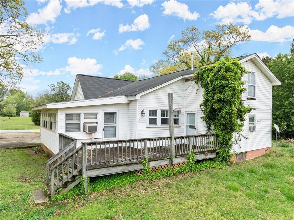 a view of a house with a backyard and deck