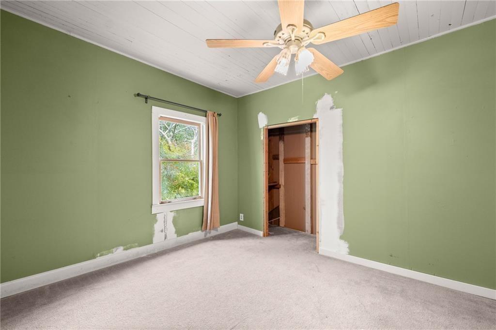 4955 Flat Creek Road Oakwood, GA 30566 - Photo 34 of 37 an empty room with a fan and a window