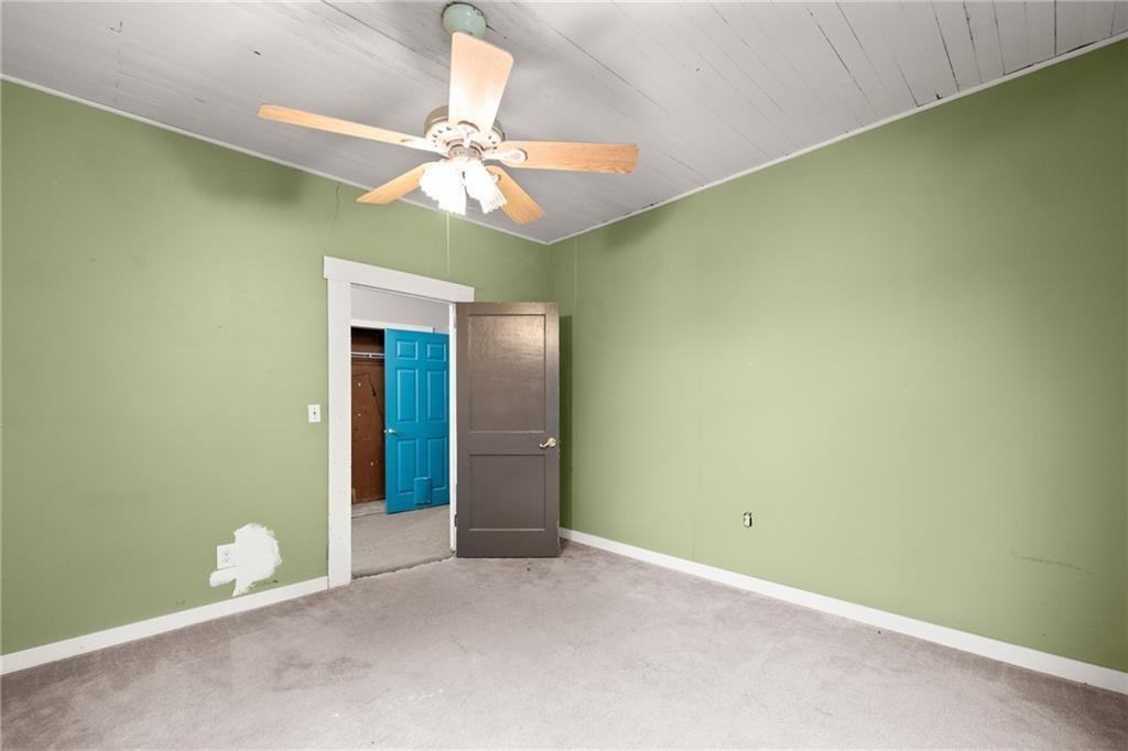 4955 Flat Creek Road Oakwood, GA 30566 - Photo 35 of 37 an empty room with a fan and a chandelier fan