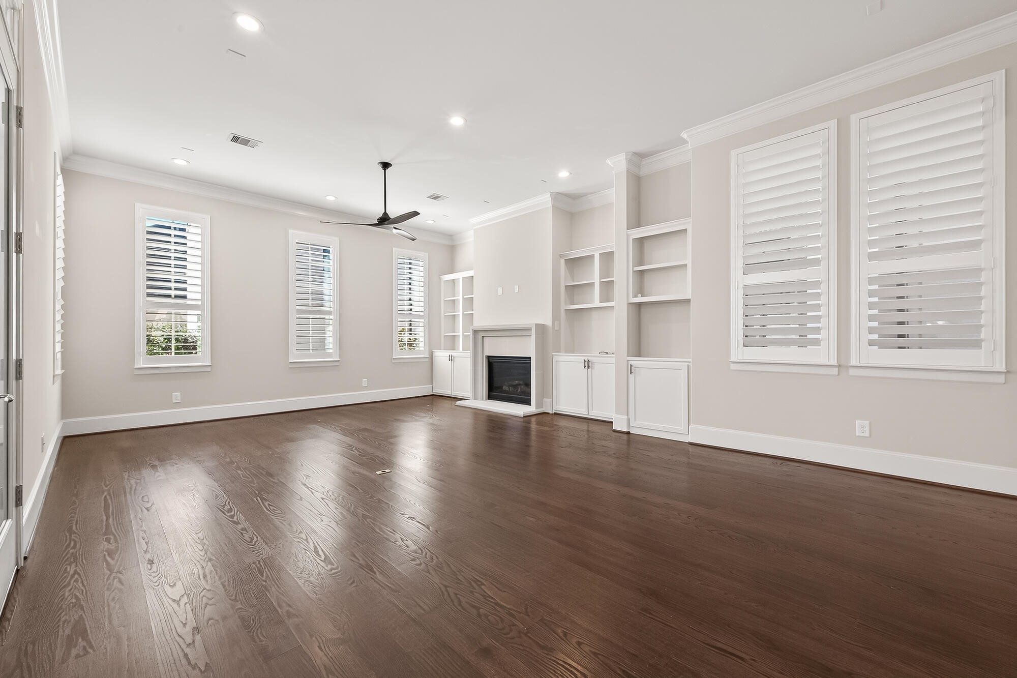 122 Gateway Park Place Spring, TX 77380 - Photo 14 of 44 a view of an empty room with wooden floor and a window