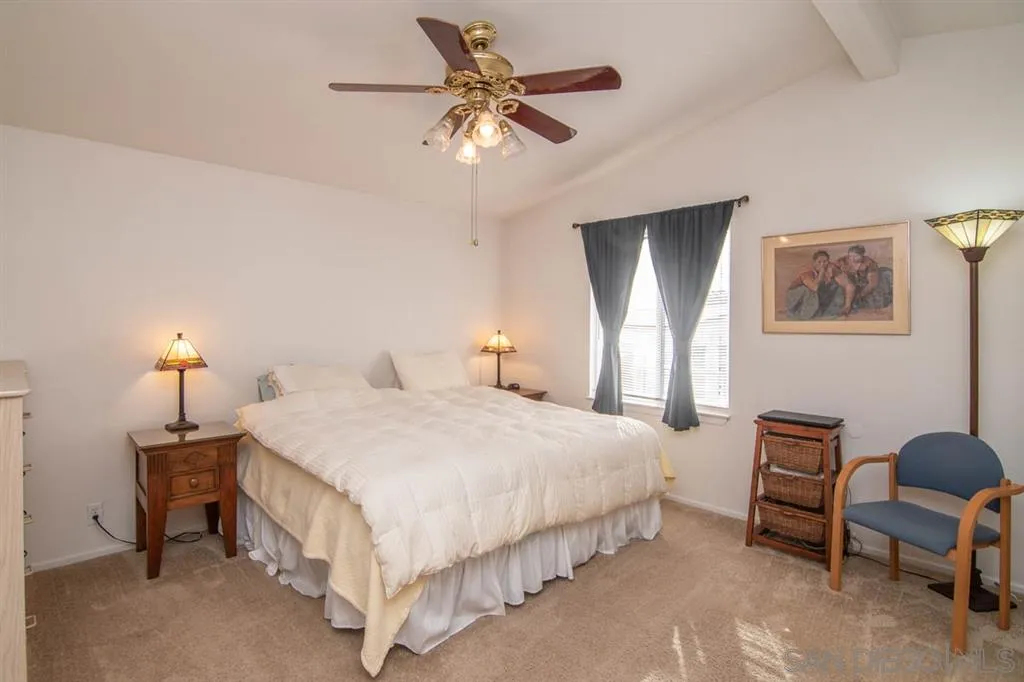 1810 Hillsdale Road, Unit 85 El Cajon, CA 92019 - Photo 13 of 23 a bedroom with a bed a chandelier and a dresser