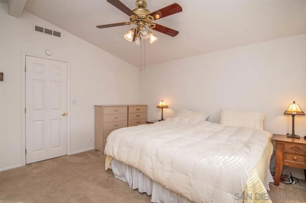 1810 Hillsdale Road, Unit 85 El Cajon, CA 92019 - Photo 14 of 23 a bedroom with a bed and a chandelier