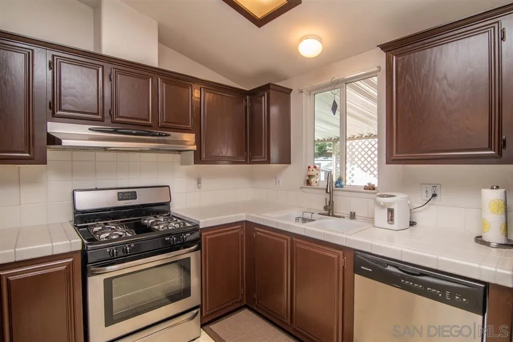1810 Hillsdale Road, Unit 85 El Cajon, CA 92019 - Photo 18 of 23 a kitchen with stainless steel appliances granite countertop a sink stove and cabinets