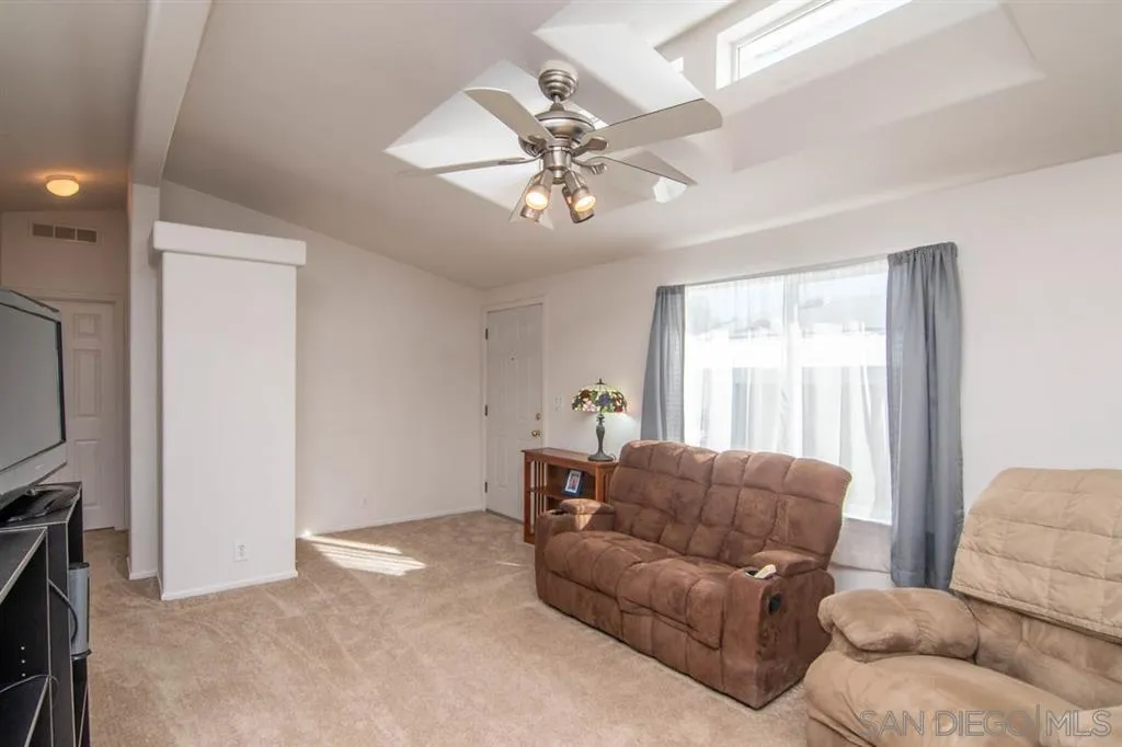 1810 Hillsdale Road, Unit 85 El Cajon, CA 92019 - Photo 6 of 23 a living room with furniture a ceiling fan and a window