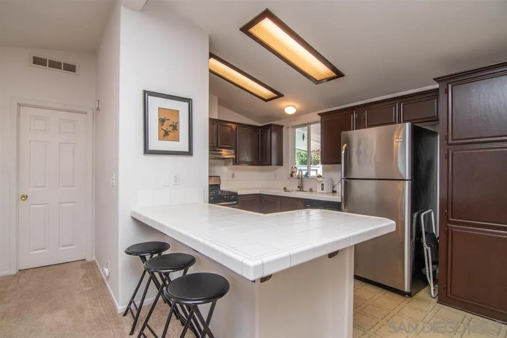 1810 Hillsdale Road, Unit 85 El Cajon, CA 92019 - Photo 7 of 23 a kitchen with stainless steel appliances a refrigerator and a refrigerator