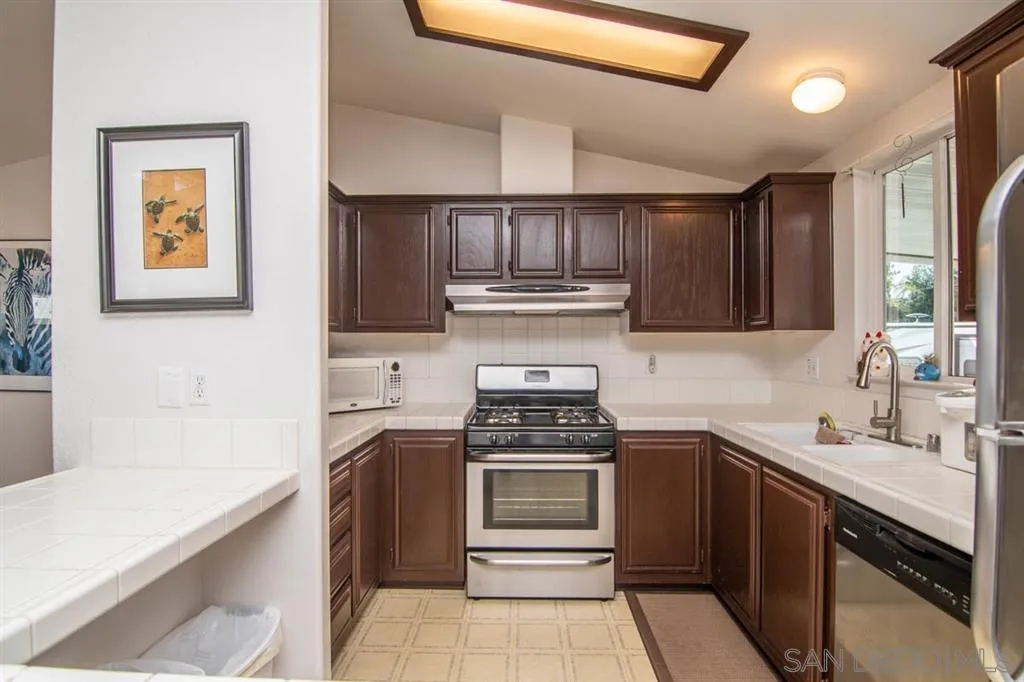 1810 Hillsdale Road, Unit 85 El Cajon, CA 92019 - Photo 8 of 23 a kitchen with stainless steel appliances a sink stove and cabinets