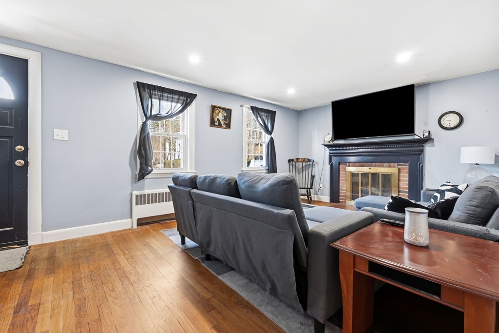 287 Main Street Saugus, MA 01906 - Photo 11 of 24 a living room with furniture and a flat screen tv