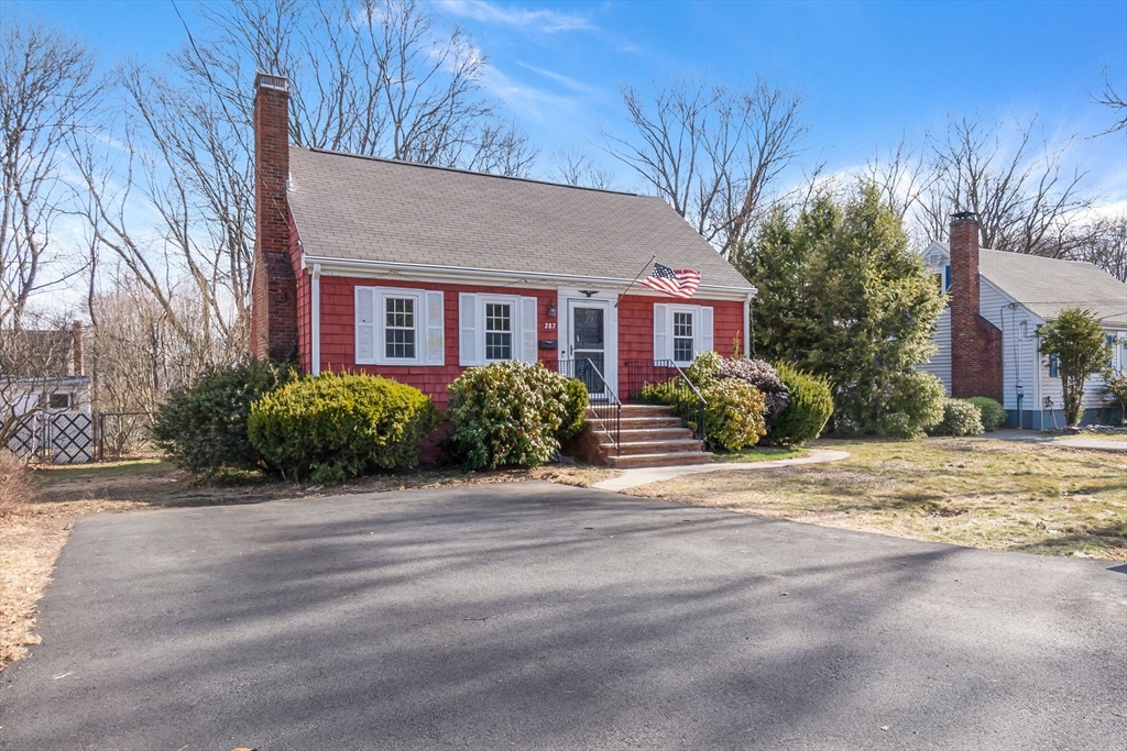 287 Main Street Saugus, MA 01906 - Photo 2 of 24 a front view of a house with a garden and trees