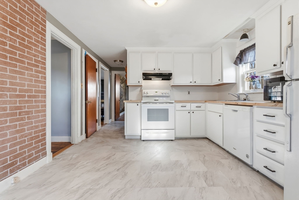 287 Main Street Saugus, MA 01906 - Photo 4 of 24 a kitchen with white cabinets and white appliances