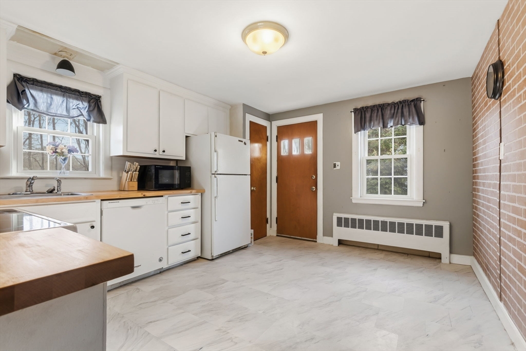 287 Main Street Saugus, MA 01906 - Photo 5 of 24 a kitchen with cabinets and a stove
