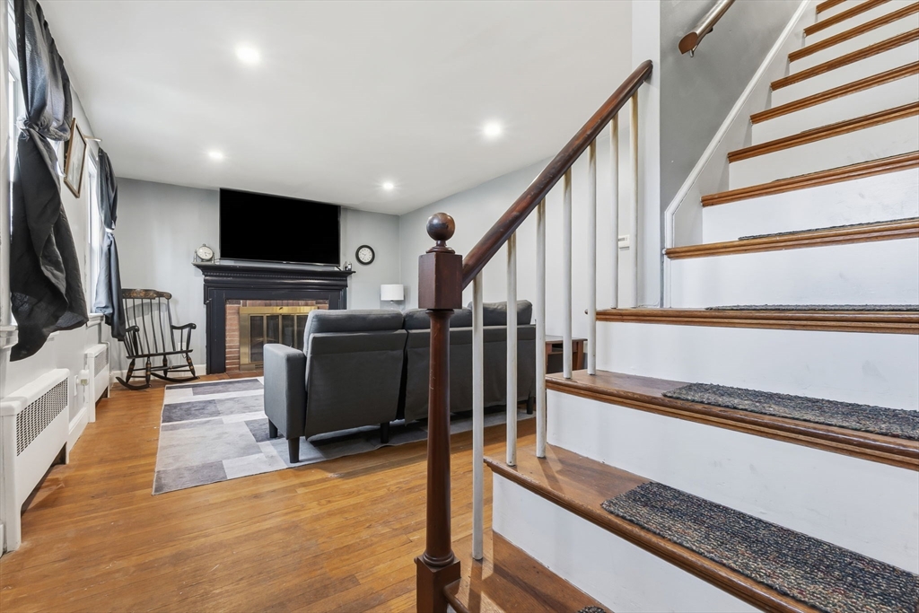 287 Main Street Saugus, MA 01906 - Photo 7 of 24 a living room with wooden floor and a flat screen tv