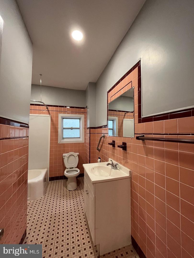 1208 Mifflin Street, Unit 2 Philadelphia, PA 19148 - Photo 9 of 11 a bathroom with a sink toilet and a mirror