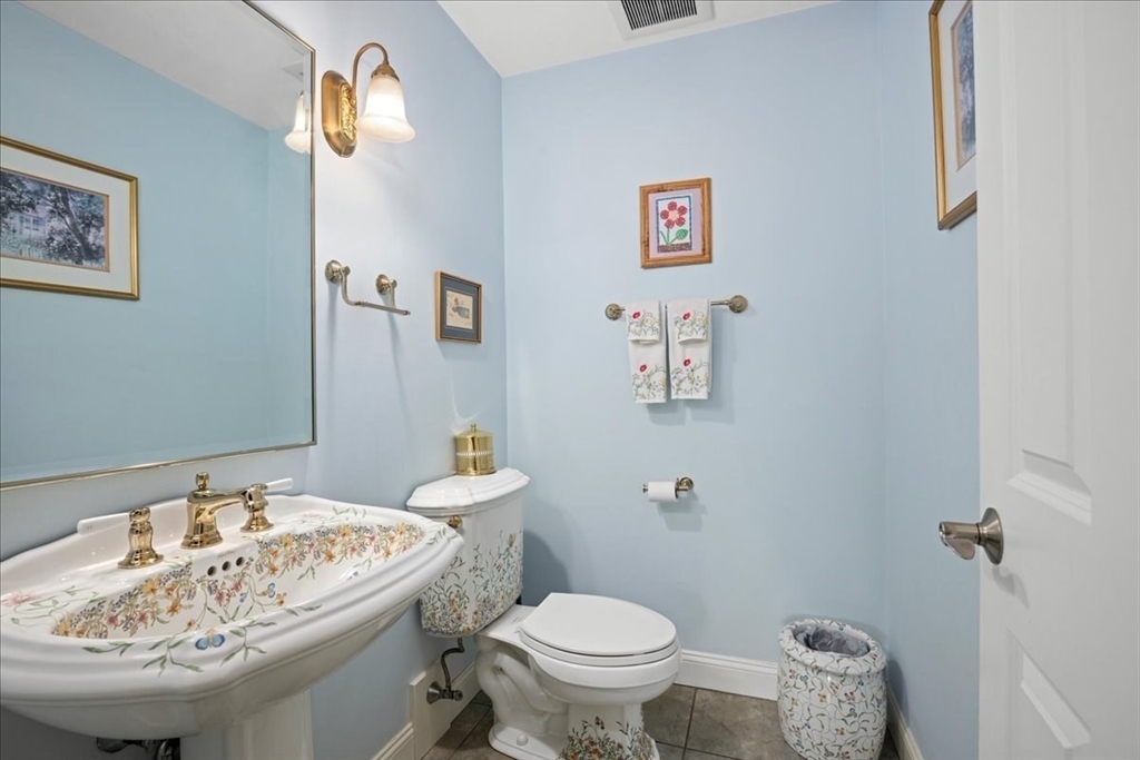 7 Primmett Lane, Unit 7 Worcester, MA 01609 - Photo 13 of 38 a bathroom with a sink a toilet and a mirror