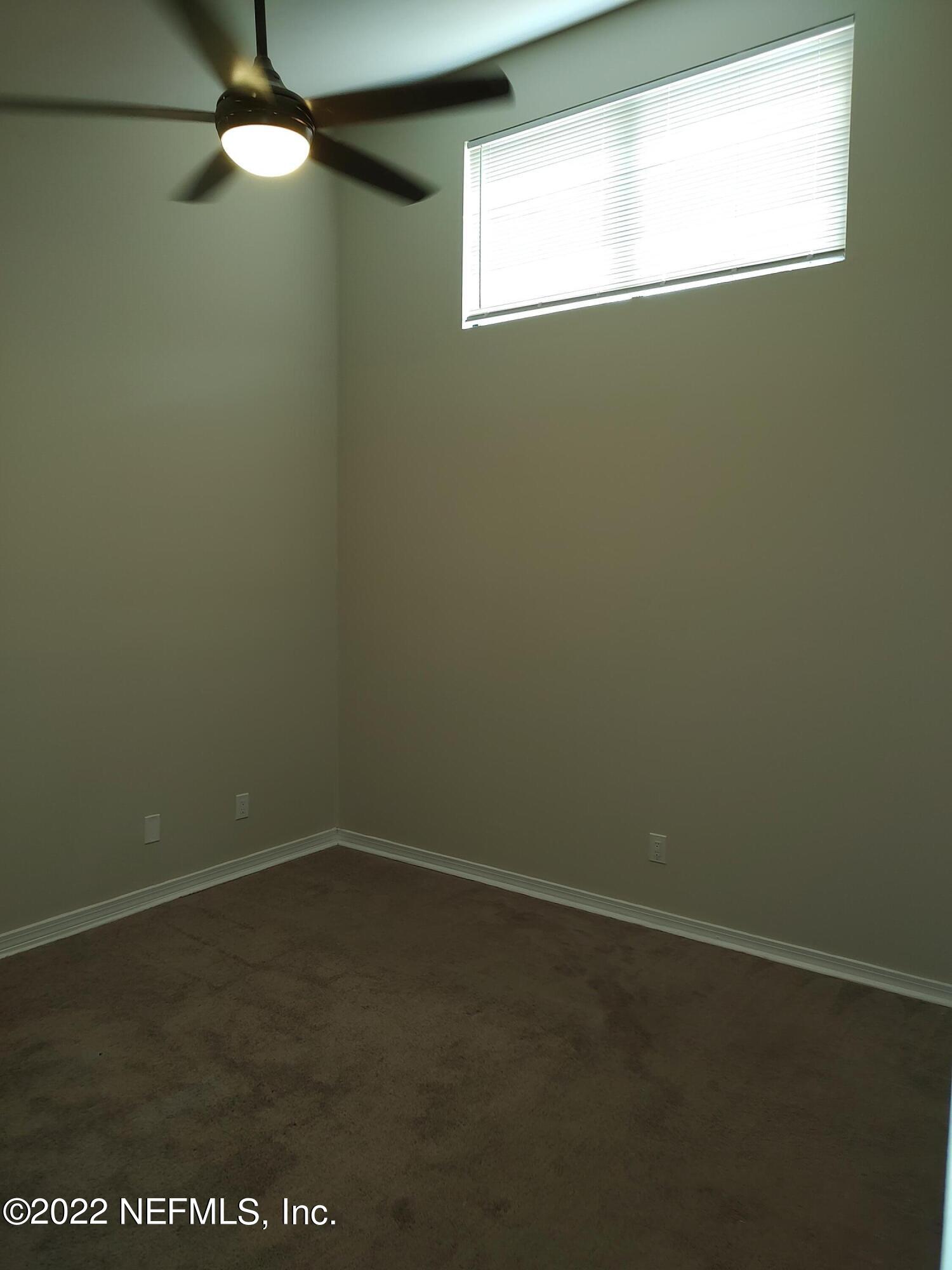 3517 Peeler Road, Unit 13 Jacksonville, FL 32277 - Photo 19 of 31 a view of a small space with wooden floor and a window