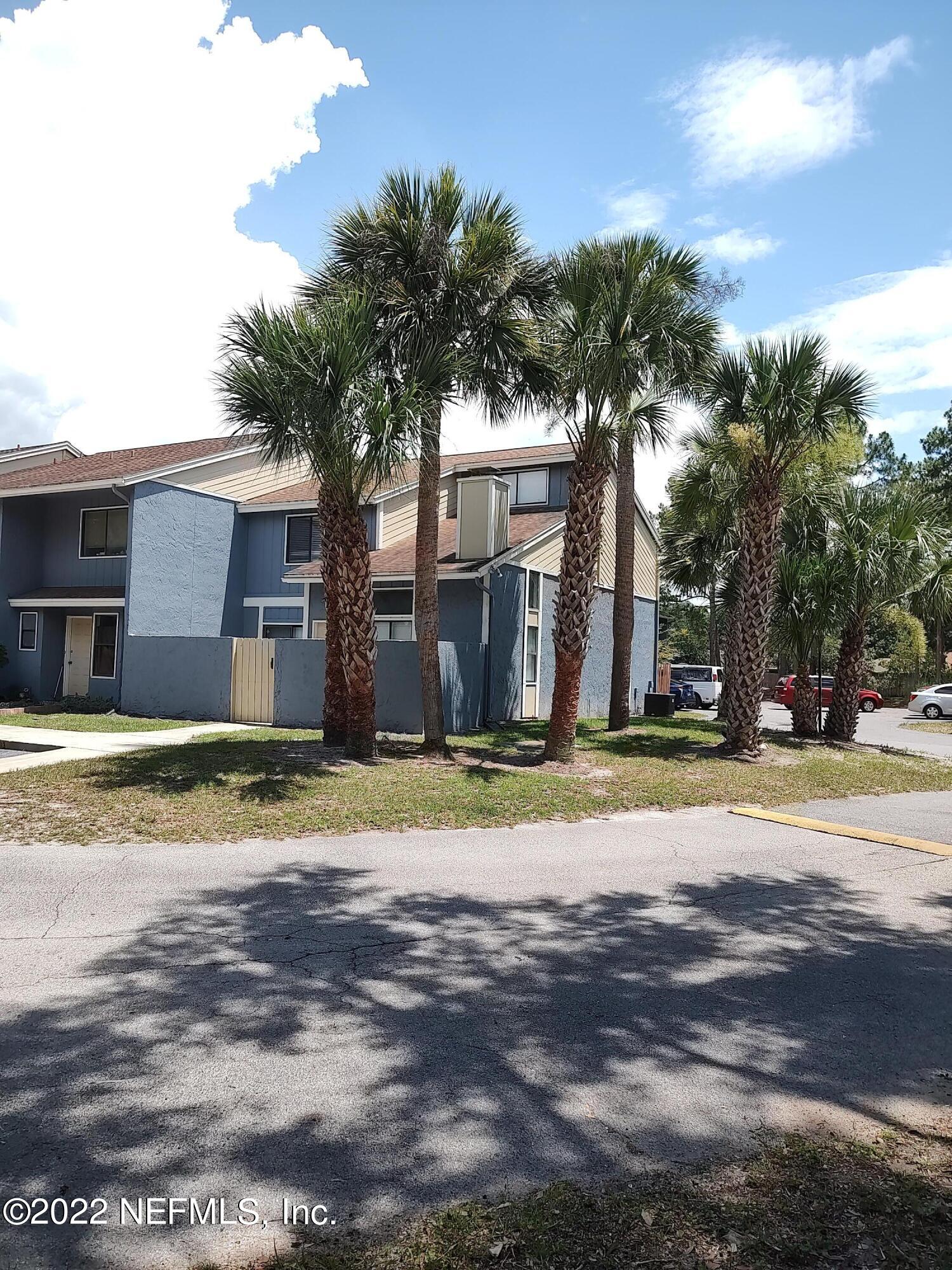 3517 Peeler Road, Unit 13 Jacksonville, FL 32277 - Photo 2 of 31 a view of a house with a yard and garage