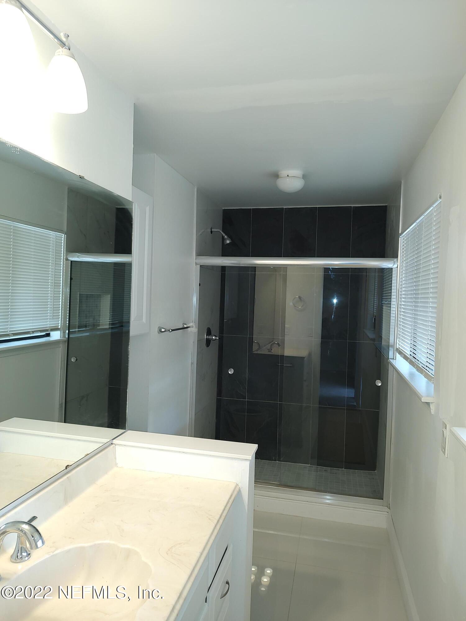 3517 Peeler Road, Unit 13 Jacksonville, FL 32277 - Photo 22 of 31 a bathroom with a shower