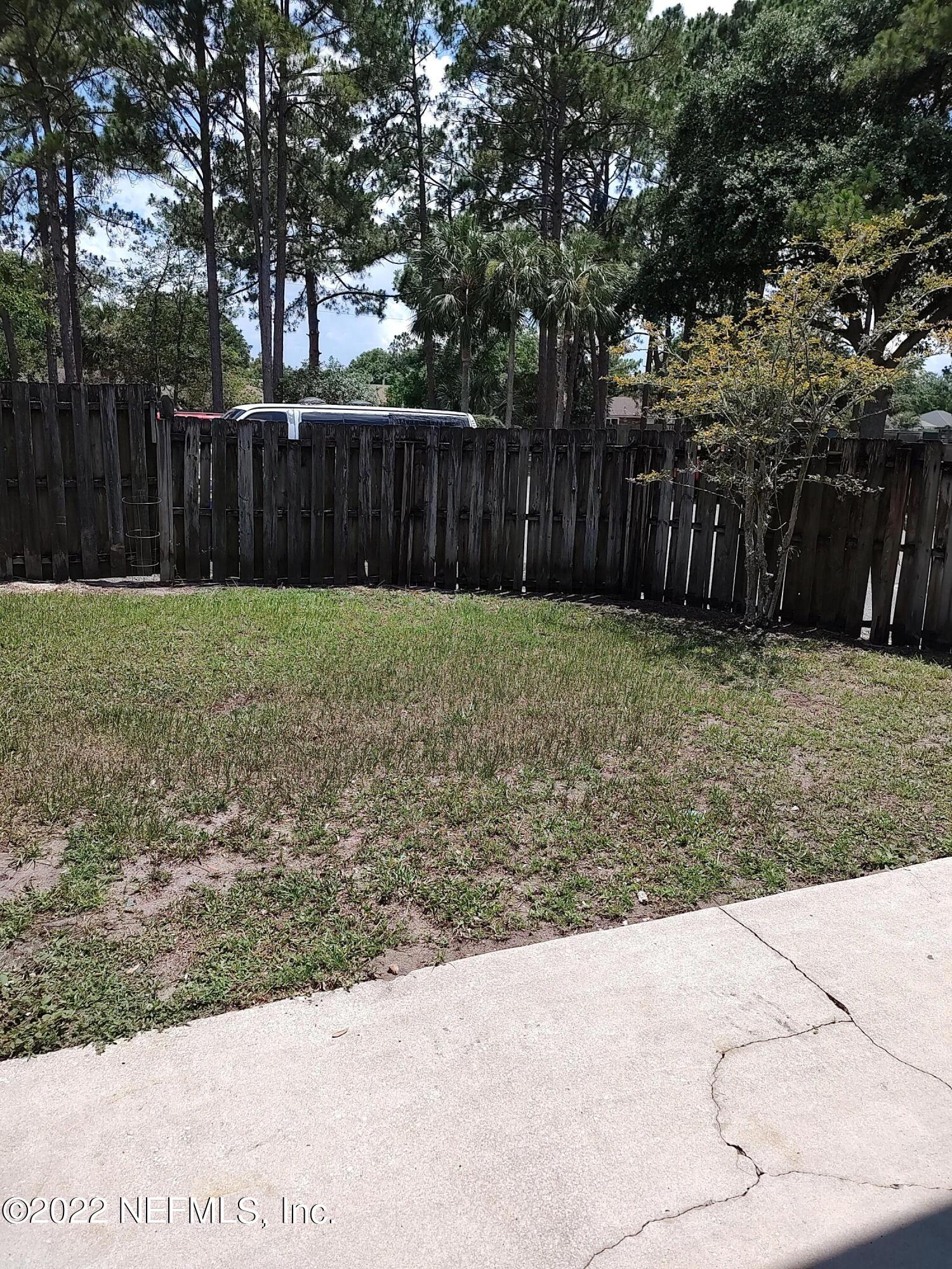 3517 Peeler Road, Unit 13 Jacksonville, FL 32277 - Photo 26 of 31 a view of a backyard with wooden fence