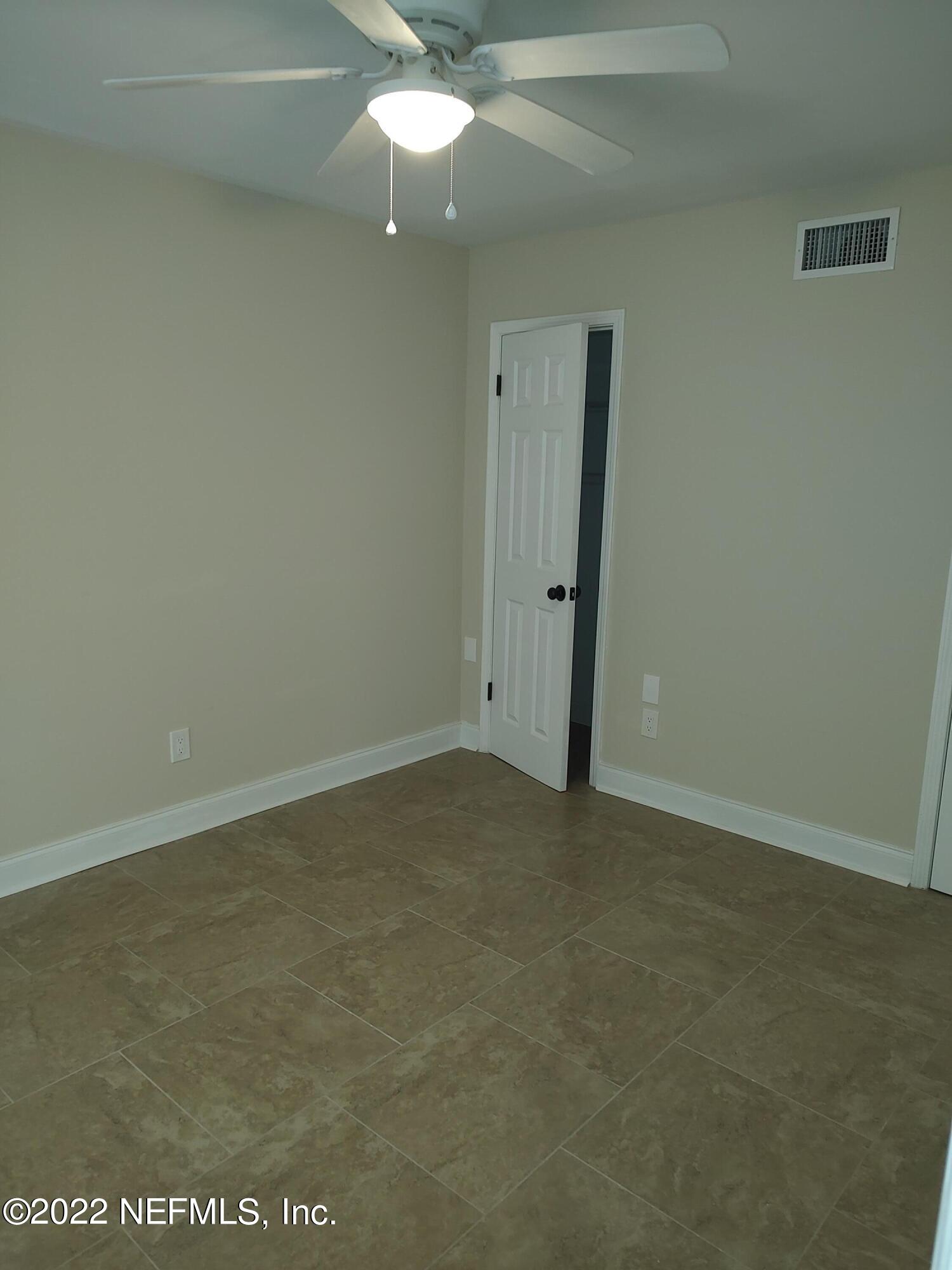 3517 Peeler Road, Unit 13 Jacksonville, FL 32277 - Photo 6 of 31 an empty room with a fan