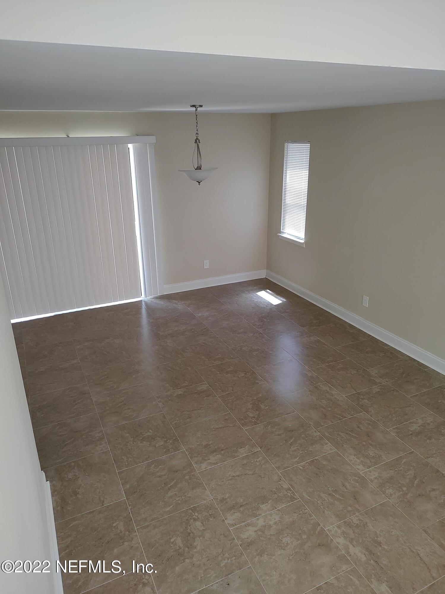 3517 Peeler Road, Unit 13 Jacksonville, FL 32277 - Photo 8 of 31 an empty room with windows and closet