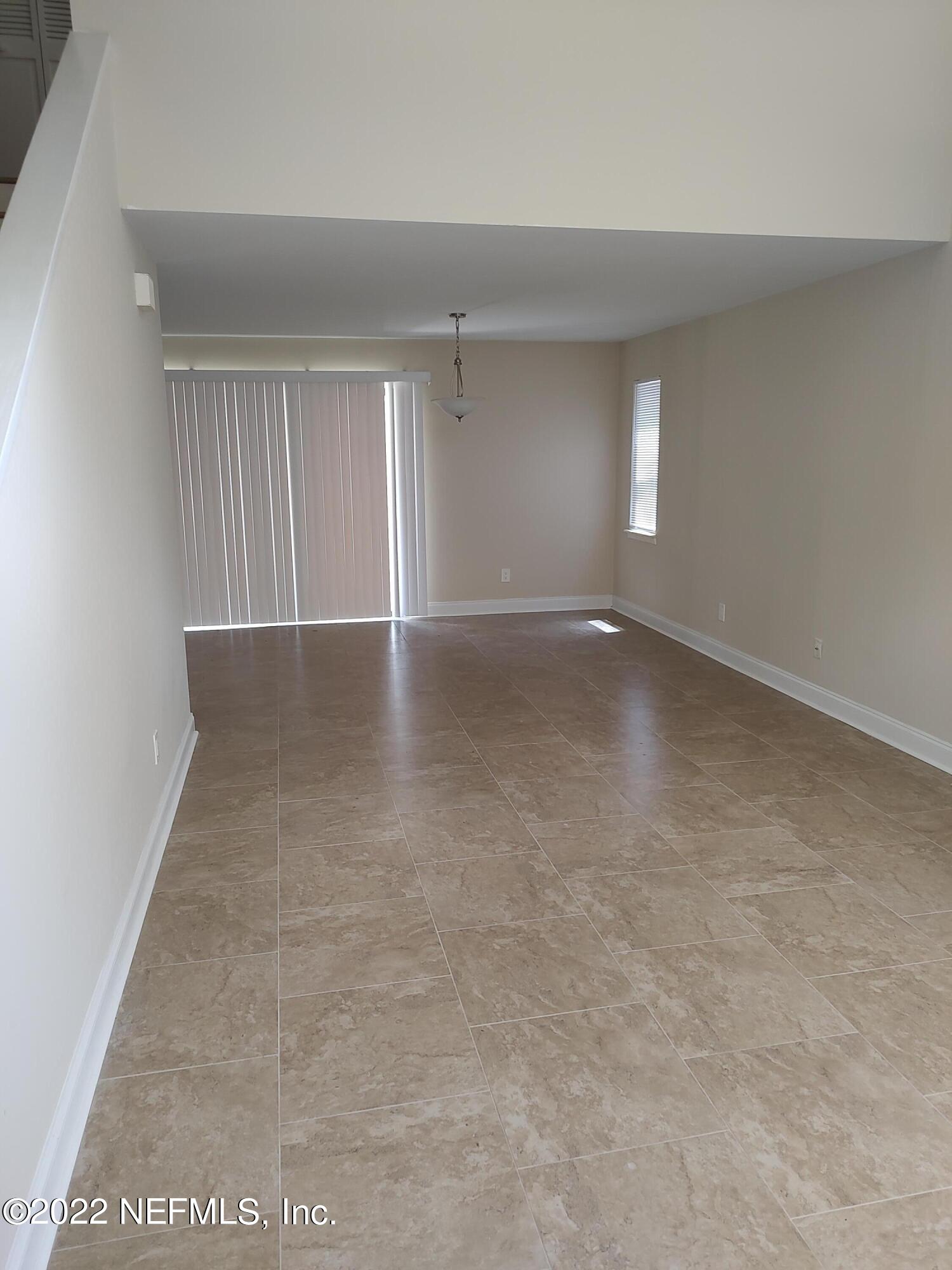 3517 Peeler Road, Unit 13 Jacksonville, FL 32277 - Photo 9 of 31 a view of an empty room with a window