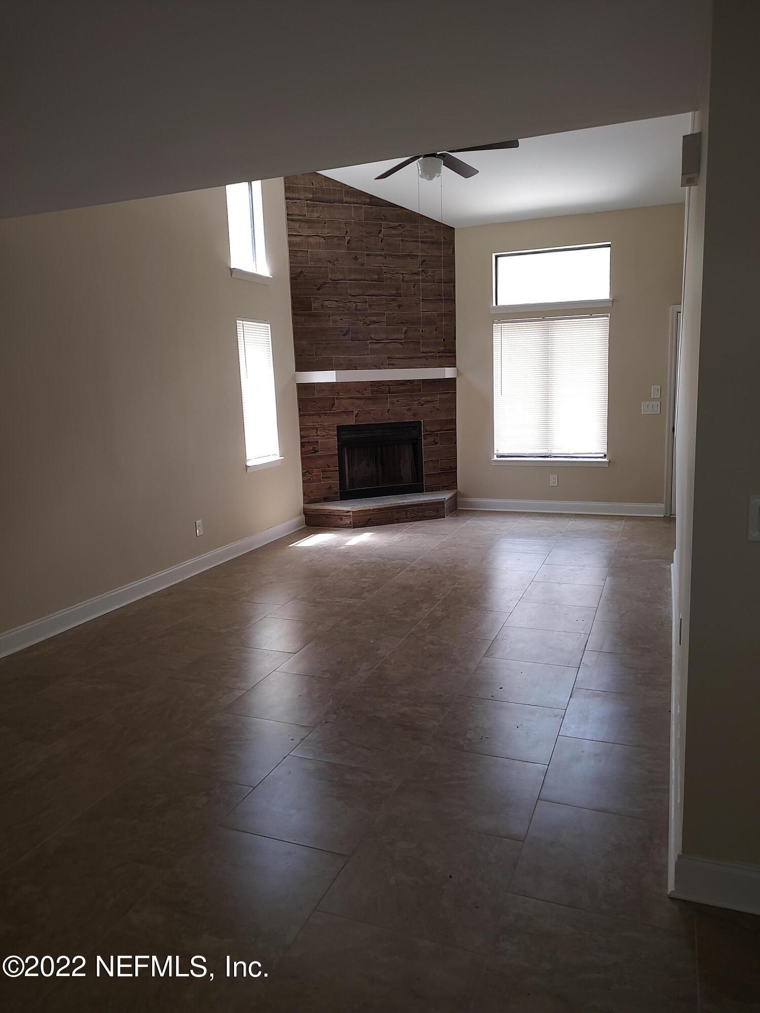 3517 Peeler Road, Unit 13 Jacksonville, FL 32277 - Photo 10 of 31 an empty room with windows and fireplace