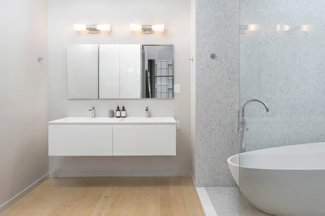 a spacious bedroom with a bed and glass window