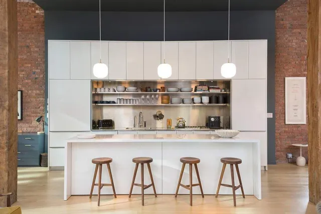 a living room with furniture a flat screen tv and kitchen view