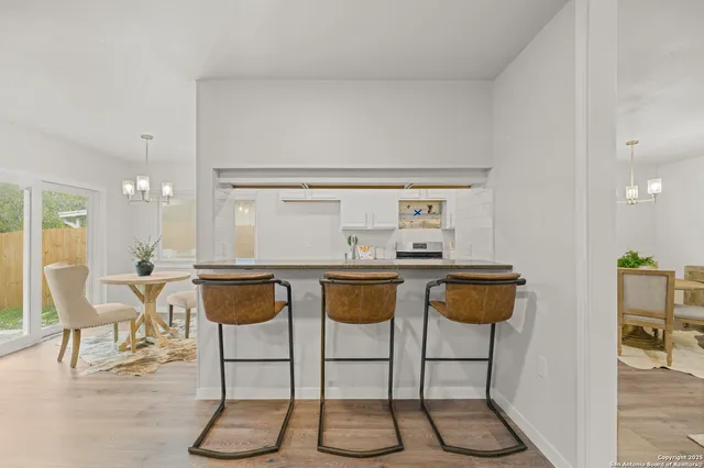 a dining room with furniture and wooden floor