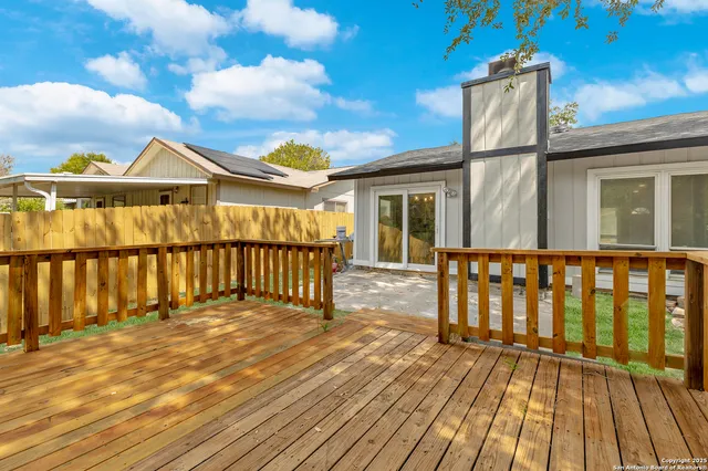 a view of a house with wooden deck