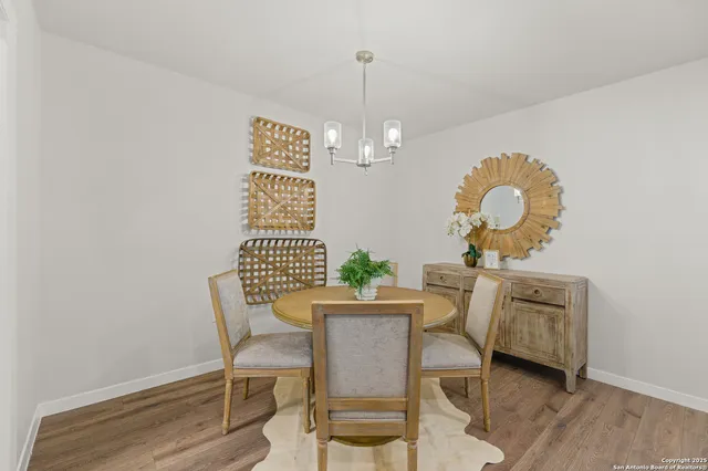a view of a dining room with furniture and chandelier