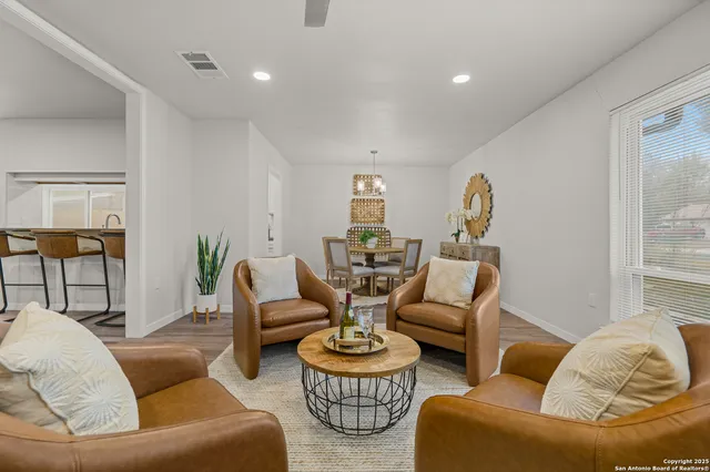 a living room with furniture and a dining table