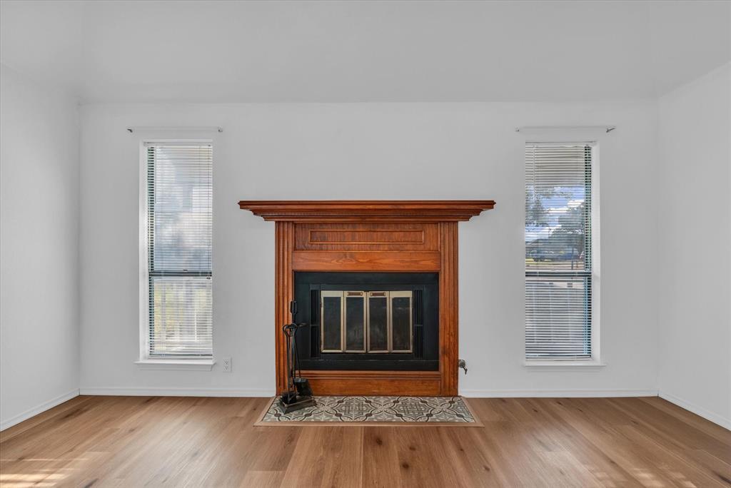 1300 Chapel Downs Waco, TX 76712 - Photo 11 of 38 a living room with wooden floor and a fireplace