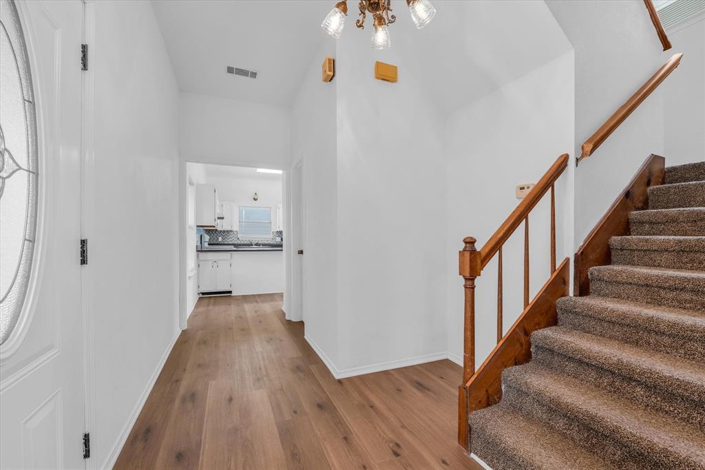 1300 Chapel Downs Waco, TX 76712 - Photo 13 of 38 a view of a hallway with wooden floor and staircase