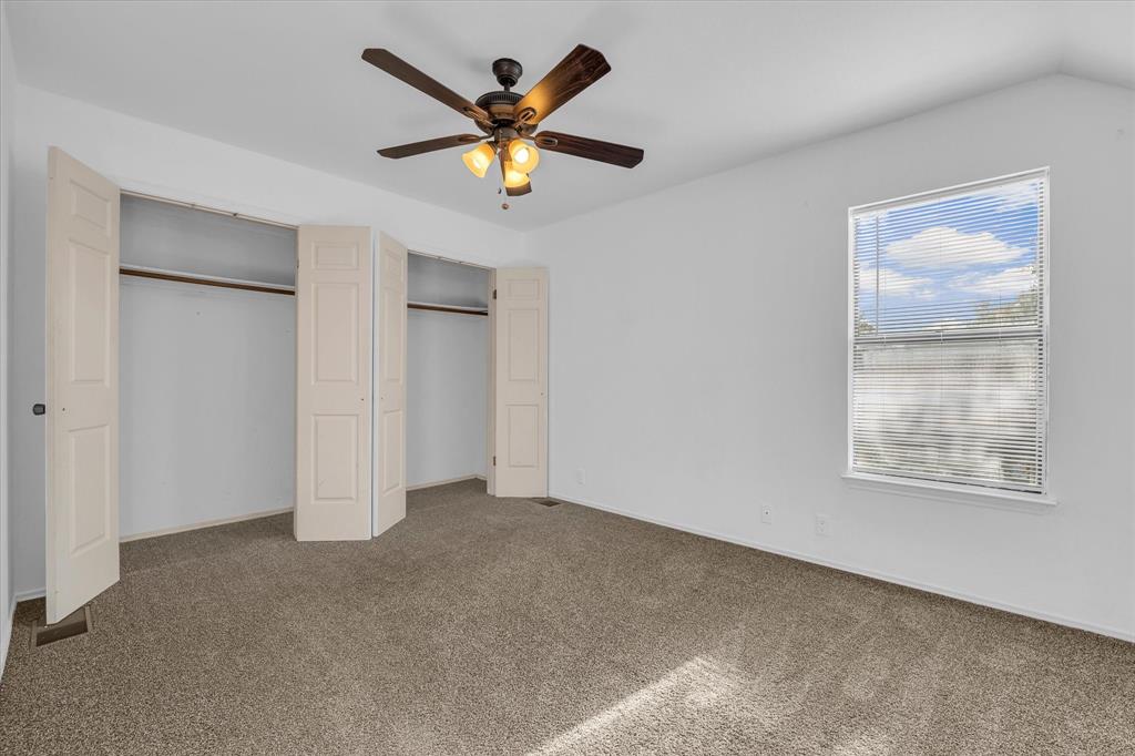 1300 Chapel Downs Waco, TX 76712 - Photo 14 of 38 an empty room with a window and a ceiling fan