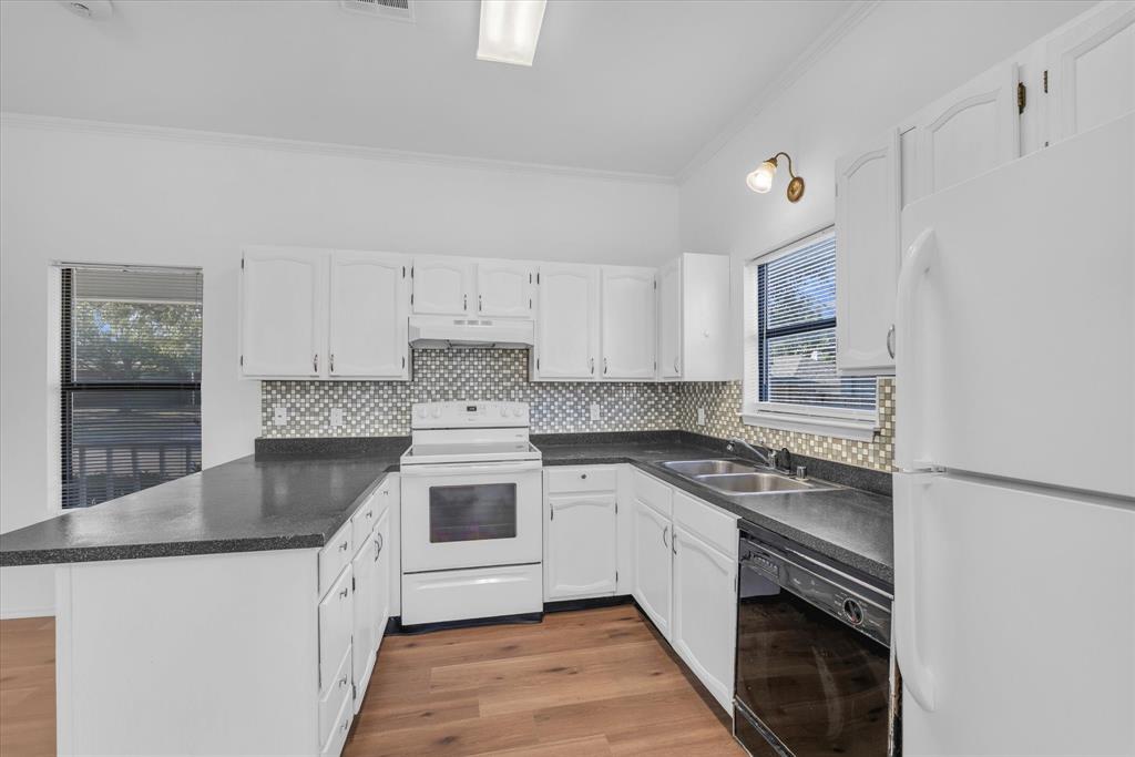 1300 Chapel Downs Waco, TX 76712 - Photo 4 of 38 a kitchen with stainless steel appliances granite countertop a stove sink and cabinets