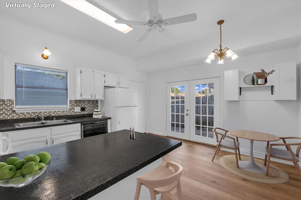 1300 Chapel Downs Waco, TX 76712 - Photo 8 of 38 a open kitchen with stainless steel appliances granite countertop a stove a sink a dining table and chairs with wooden floor