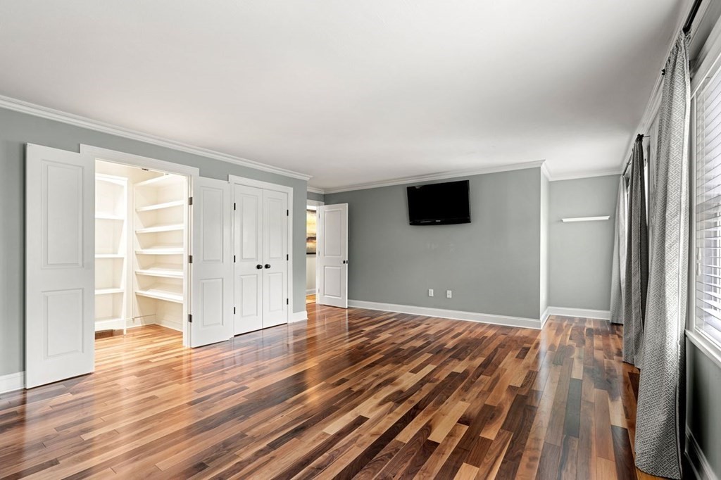 22 Fosters Pond Road Andover, MA 01810 - Photo 21 of 42 an empty room with wooden floor and windows