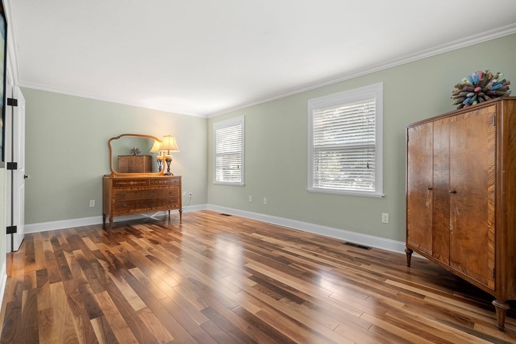 22 Fosters Pond Road Andover, MA 01810 - Photo 25 of 42 a view of a bedroom with wooden floor electronic appliances and windows