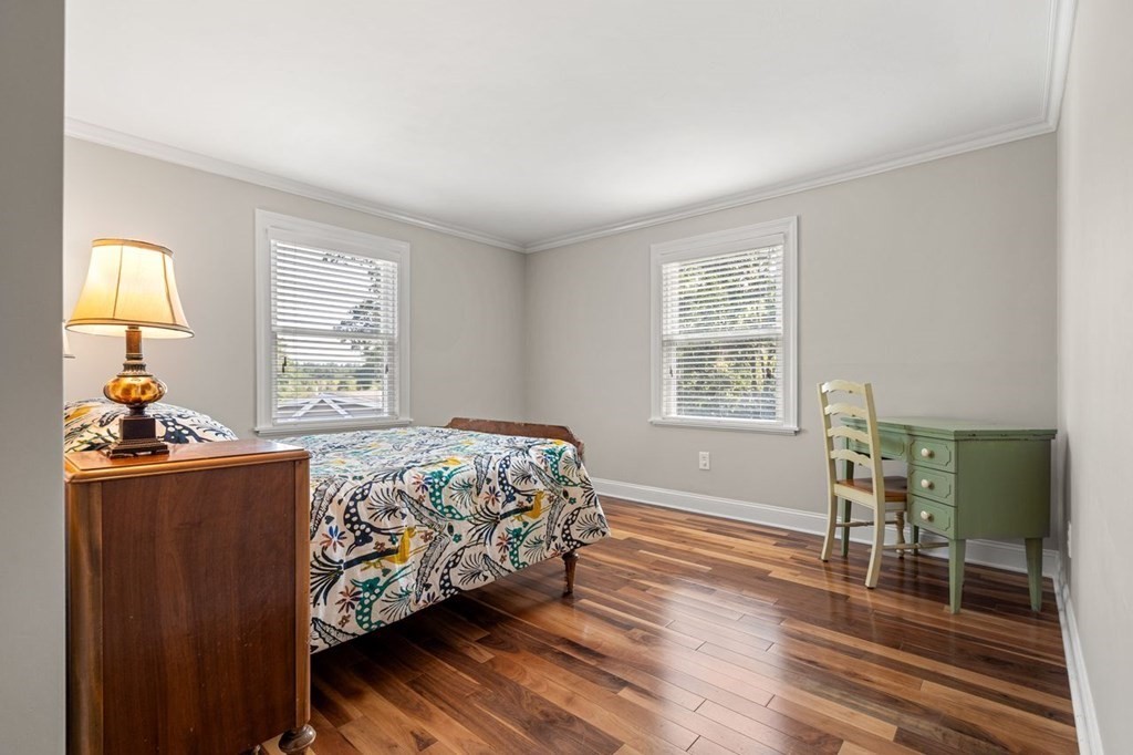 22 Fosters Pond Road Andover, MA 01810 - Photo 26 of 42 a bedroom with a bed and wooden floor