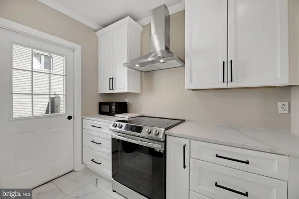 a kitchen with stainless steel appliances white cabinets and a stove a sink