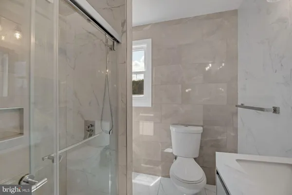a white toilet sitting next to a bathroom sink