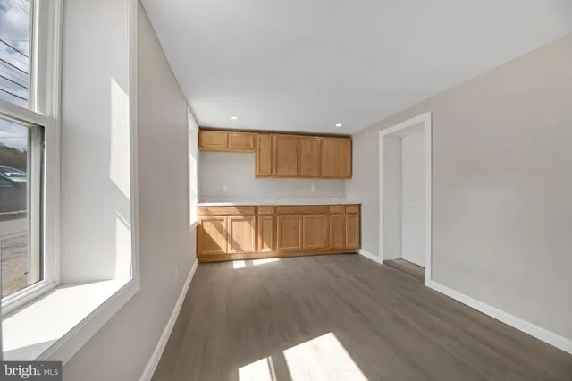 a view of a room with wooden floor and a window
