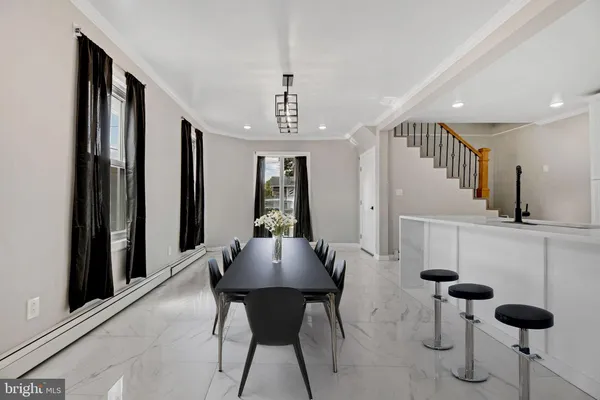 a view of a dining room with furniture and chandelier