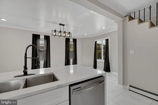 a kitchen with refrigerator and sink