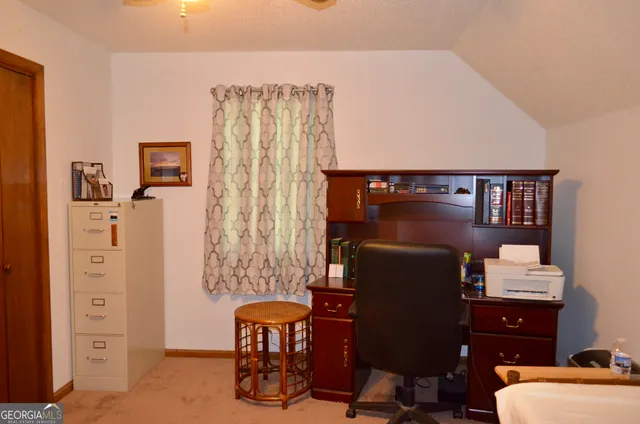 a bedroom with a bed and a wall painting