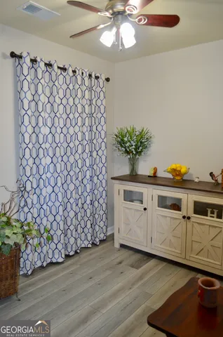 a vase of flowers sitting on a wooden floor