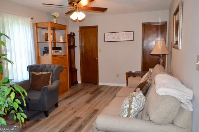 a view of a chairs and table in the backyard